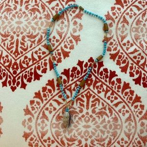 Handmade beaded necklace with a real shell.